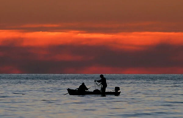 Two men fish in the Black Sea near the Georgian town of Gagra in the Abkhazia region