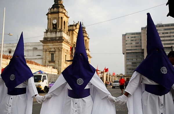 Men take part in a Procession of Jesus Nazareno de Candelaria Cristo Rey in the streets