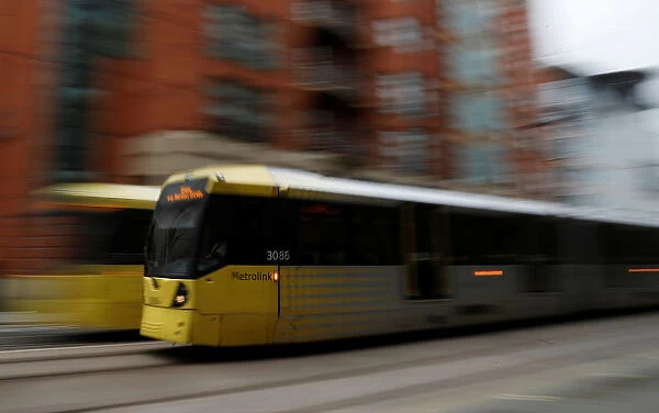 A Metrolink tram travels through the centre of Manchester