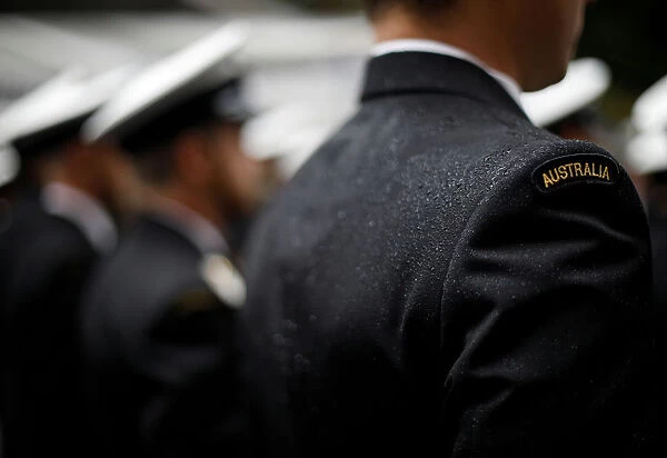 A military serviceman marches in the rain during an Anzac Day parade in Sydney