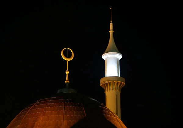A minaret and a crescent moon on the Abuja central mosque are illuminated as Nigerian
