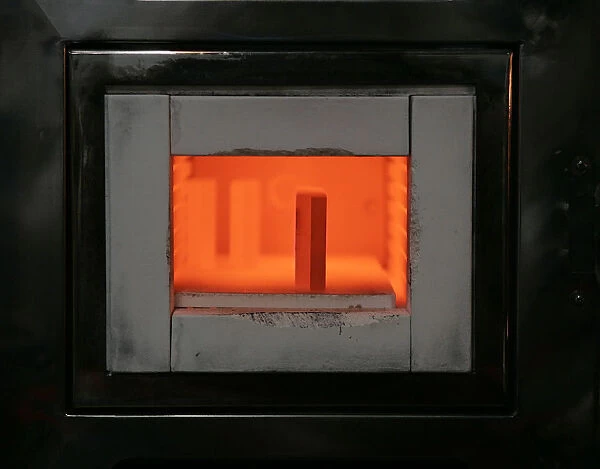 A mold for forming gold bars is kept at high-temperature in an oven at a Tanaka Kikinzoku