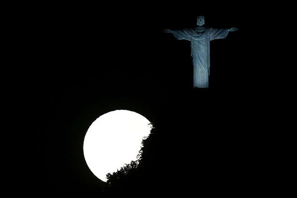 The full moon is pictured next to the Christ the Redeemer statue ahead of the 2016