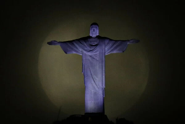 The moon is pictured behind the Christ the Redeemer statue ahead of the visit of Pope