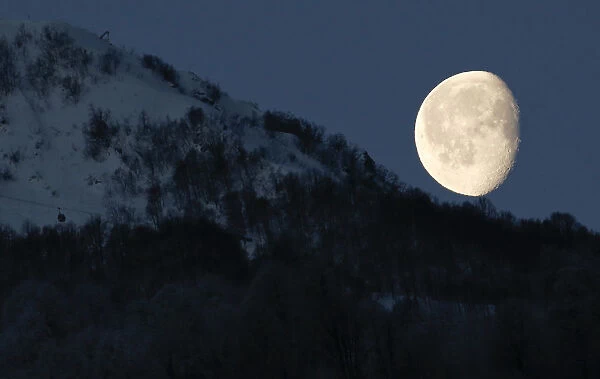 Moon is pictured above the mountains in Rosa Khutor during the 2014 Sochi Winter Olympics
