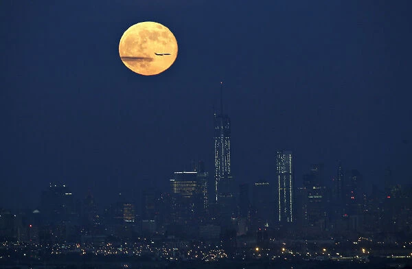 A full moon also referred to as a super moon rises over New York as seen from West Orange