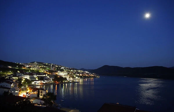 The moon is reflected in the sea in the town of Neum