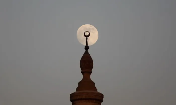 Framed Print : The full Moon rises over a minaret of a mosque during sunset on the 12th day of Framed Print : The full Moon rises over a minaret of a mosque during sunset on the 12th day of