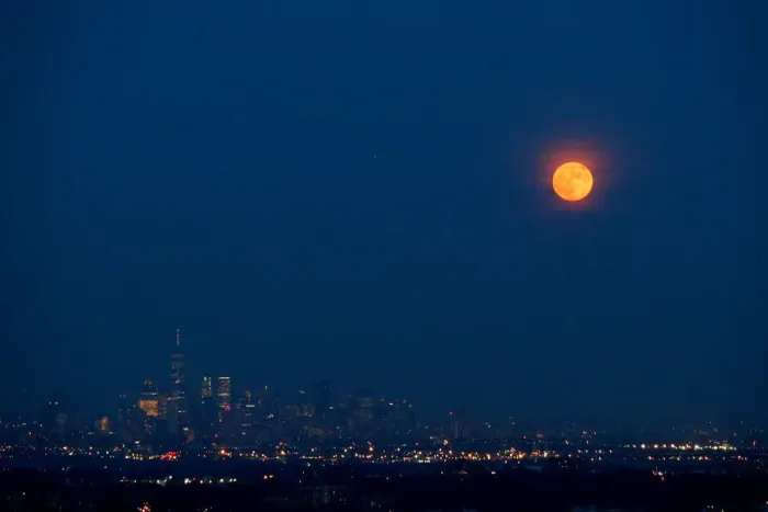 Framed Print : The full moon rises over the skyline of New York and One World Trade Center as seen Framed Print : The full moon rises over the skyline of New York and One World Trade Center as seen