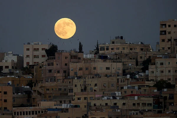 The moon is seen before a lunar eclipse over Amman