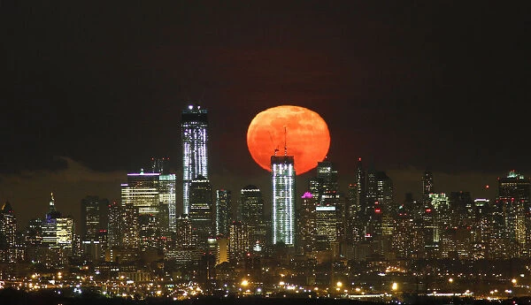 A full moon as seen from West Orange, New Jersey, rises over the skyline of Lower