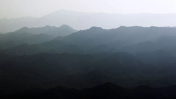 A morning fog rests over a mountain range in Afghanistans Paktiya Province
