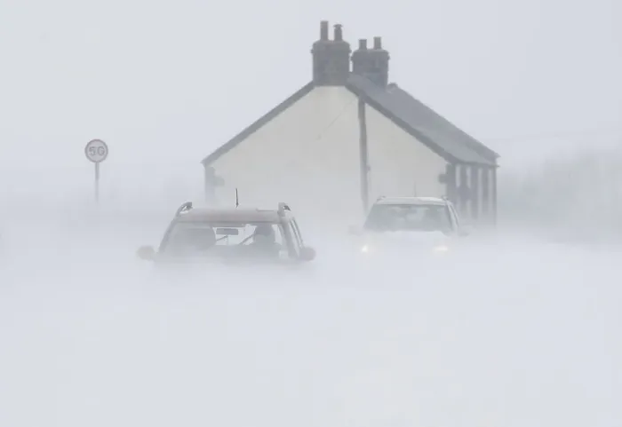 Framed Print : Motorists drive through snow blown from fields near Buxton in central England Framed Print : Motorists drive through snow blown from fields near Buxton in central England
