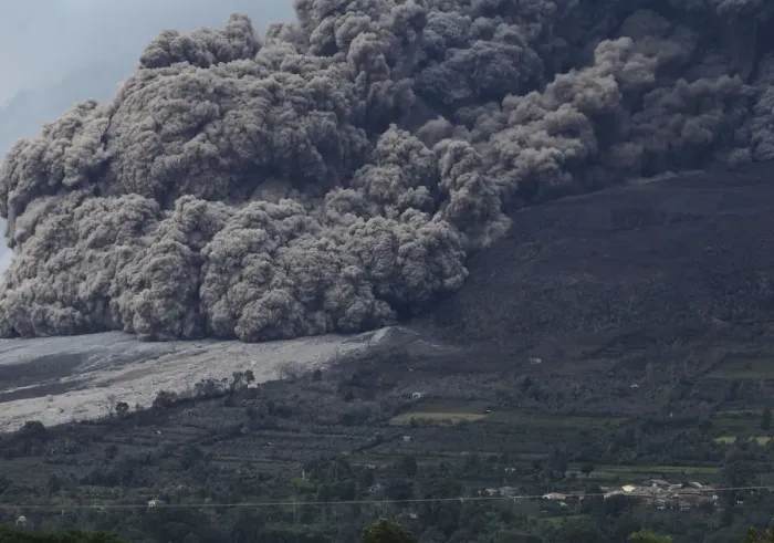 Framed Print : Mount Sinabung volcano spews ash during an eruption, as seen from Berastepu village in