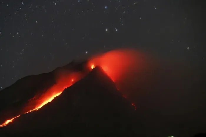 Framed Print : Mount Sinabung volcano spews hot lava as seen from an empty village inside the danger