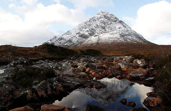 The mountain Buachaille Etive Mor is reflected in the slow flowing river Coupall near Ballachulish