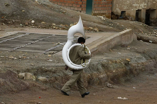 A musician walks by during the miners carnival near Cerro Rico in Potosi