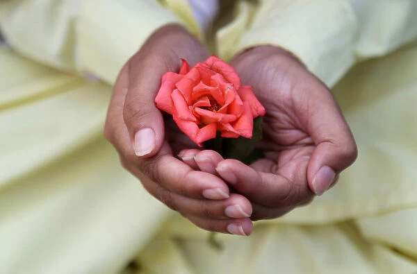 A Muslim boy holds a rose after offering Eid al-Fitr prayers marking the end of the