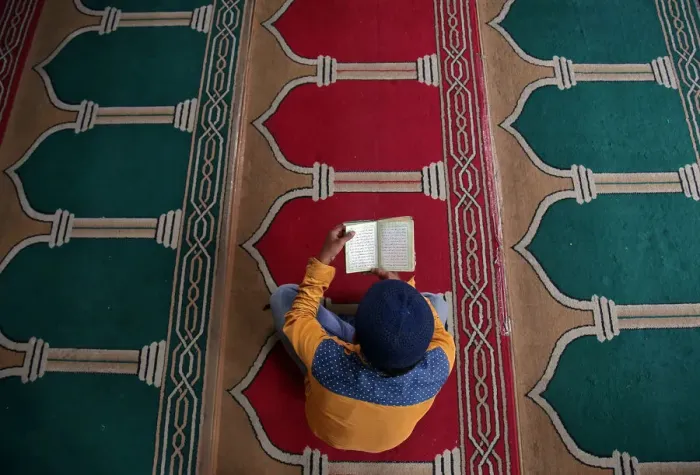 Framed Print : A Muslim man reads the Koran inside a mosque during the holy month of Ramadan in Framed Print : A Muslim man reads the Koran inside a mosque during the holy month of Ramadan in