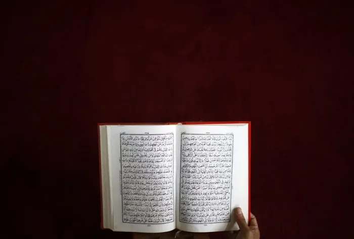 Framed Print : A Nepalese Muslim reads the Koran during the month-long fasting in the holy month of