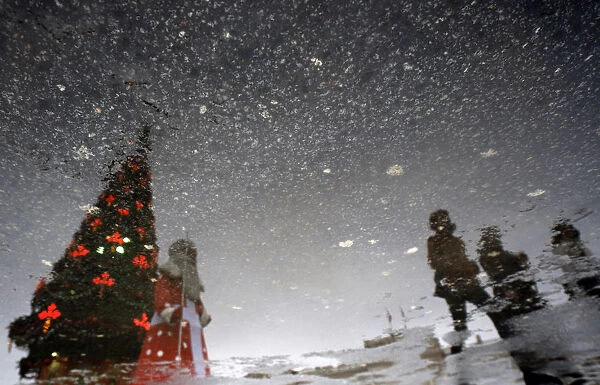 The New Year tree, Father Frost, the Russian equivalent of Santa Claus, and pedestrians