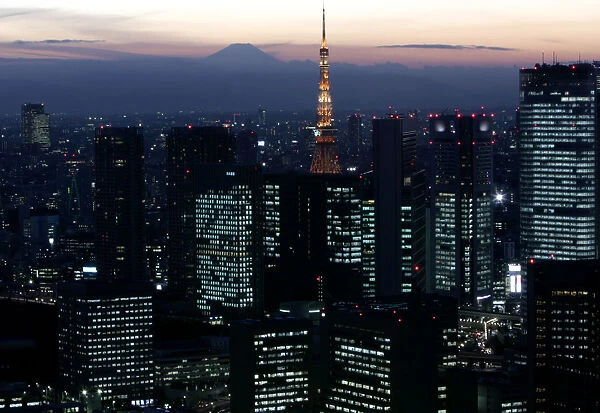 Night view shows Japans highest Mt. Fuji seen beyond Tokyo Tower and Shiodome district