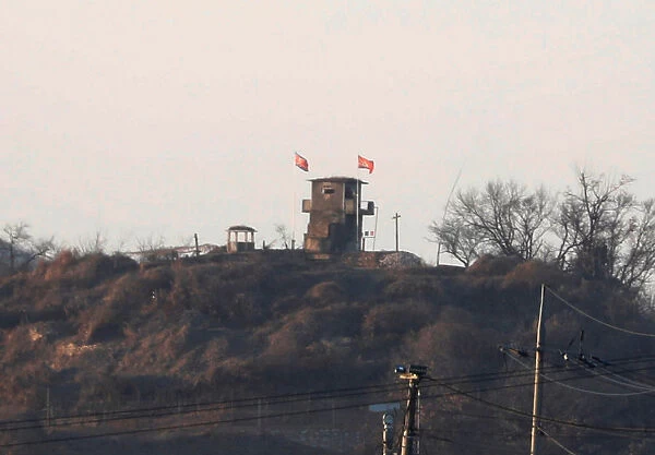 A North Korean flag flutters on the top of their guard post inside North Korean territory