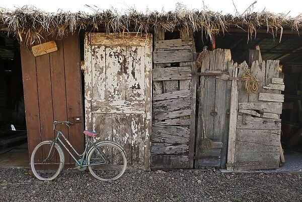 An old bicycle and old doors of different ages are seen in a storage of the Museum