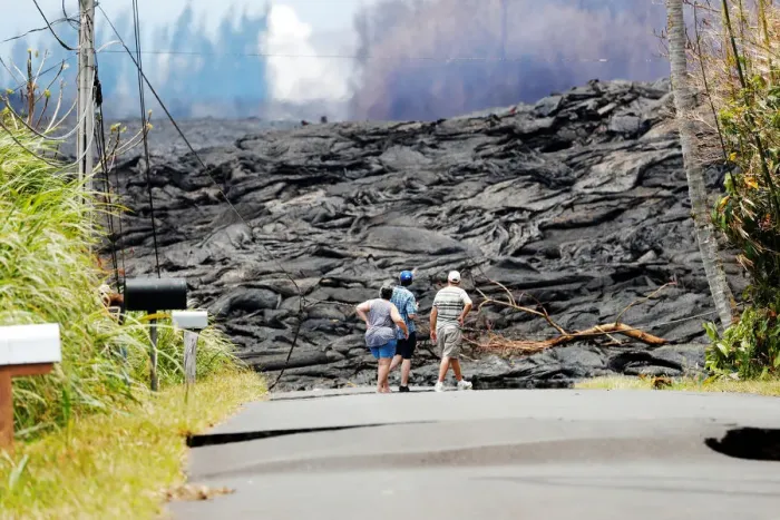 Framed Print : Onlooks stare at the lava field from the eruption of the Kilauea Volcano in the Leilani