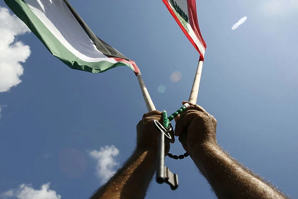 A Palestinian carries a symbolic key during a protest in Beirut