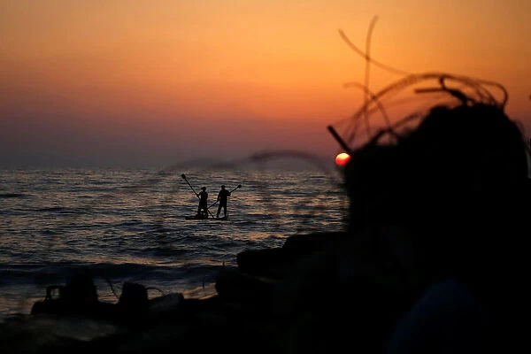Palestinians ride a boat in the Mediterranean Sea in the northern Gaza Strip