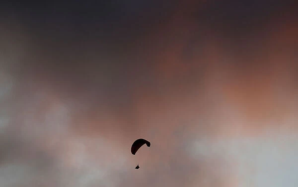 A paraglider flies above the Sao Conrado beach in Rio de Janeiro