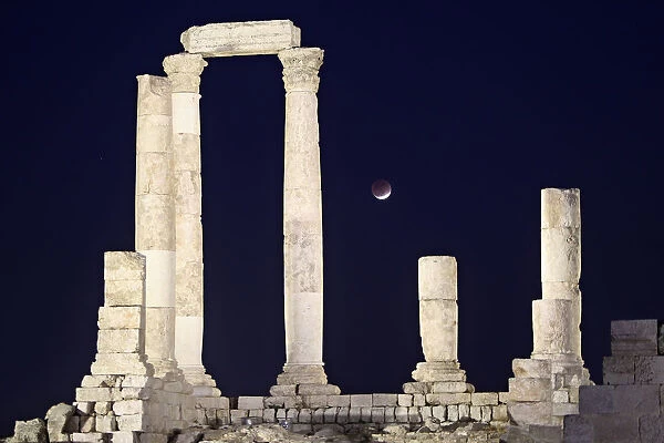 A partial lunar eclipse is seen from the Roman pillars of the Temple of Hercules in Amman