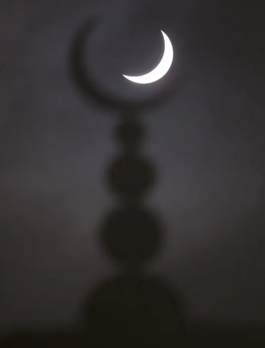 Framed Print : A partial solar eclipse in seen above a mosque in Oxford Framed Print : A partial solar eclipse in seen above a mosque in Oxford