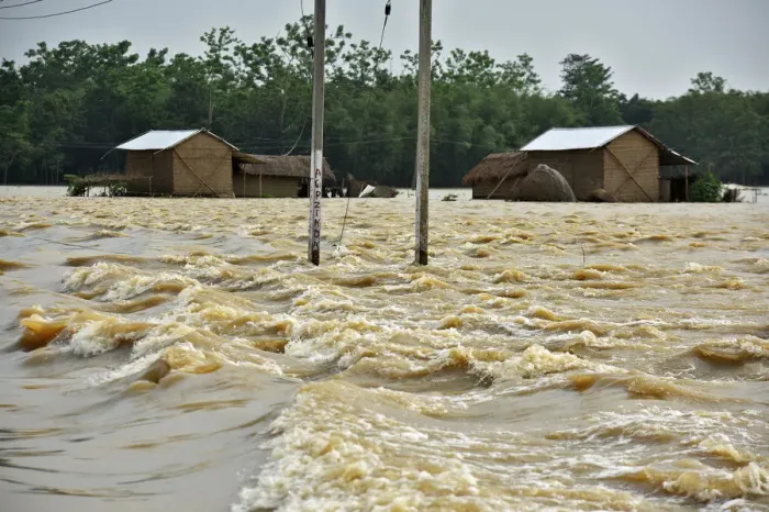 Framed Print : Partially submerged houses are seen at a flood-affected village in Hojai district