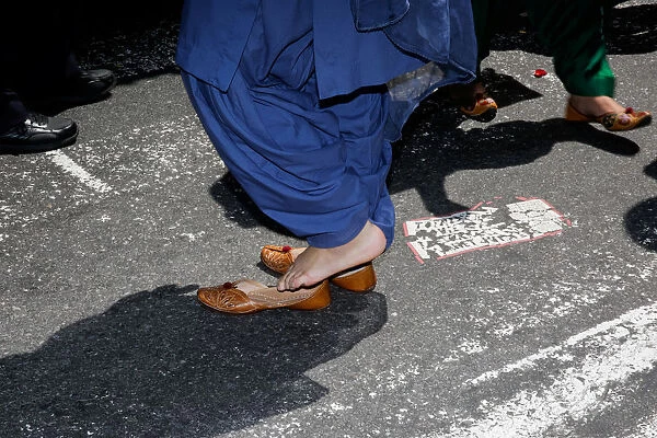 A participant puts her shoes on after taking them off to do an offering at the Annual