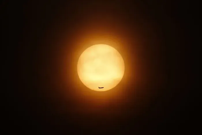 Framed Print : A passenger jet flies past the setting sun in Shanghai Framed Print : A passenger jet flies past the setting sun in Shanghai