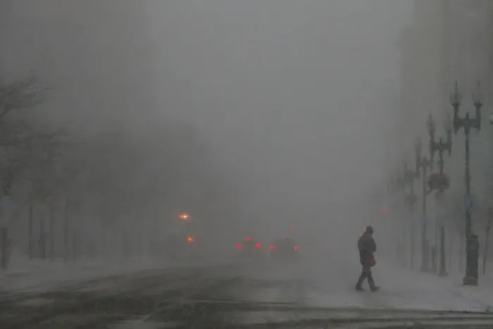 Framed Print : A pedestrian crosses Boylston Street during a winter snow storm in Boston