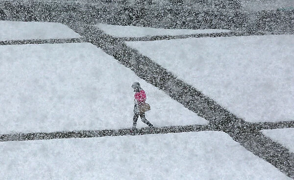 A pedestrian walks during a heavy snowfall in the Siberian town of Divnogorsk
