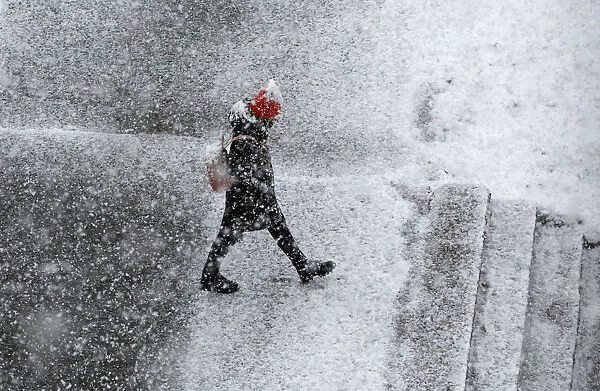 A pedestrian walks during a heavy snowfall in the Siberian town of Divnogorsk
