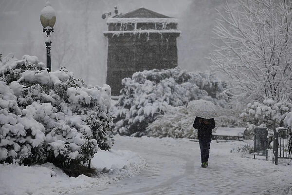 A pedestrian walks through the snow outside the U. S. Capitol in Washington