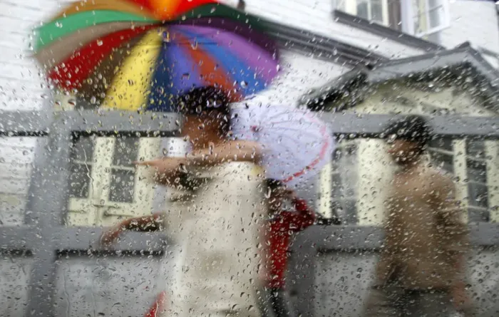 Framed Print : Pedestrians are seen through a car window during rainfall in Darjeeling Framed Print : Pedestrians are seen through a car window during rainfall in Darjeeling