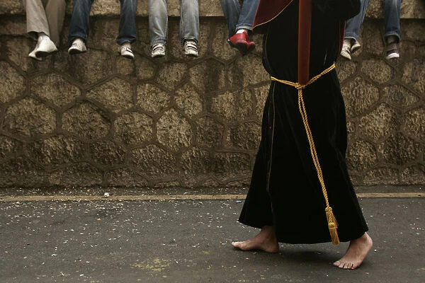Penitent takes part in the procession of Penas brotherhood during Holy Week in Malaga