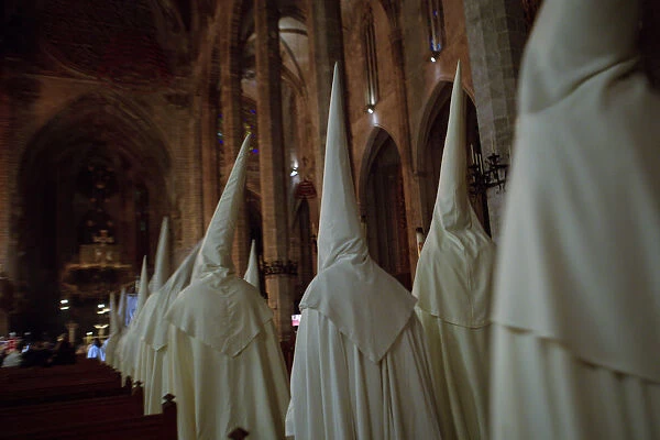 Penitents enter Palmas Cathedral at the end of Sant Crist de la Sang Holy Week