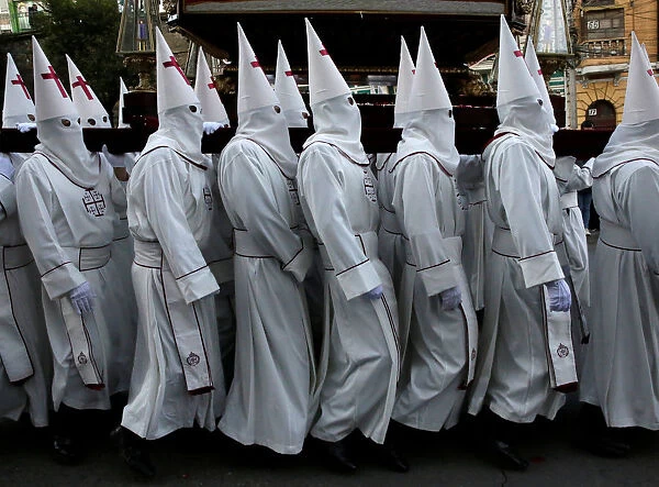 Penitents take part in the procession of the Santo Sepulcro in La Paz