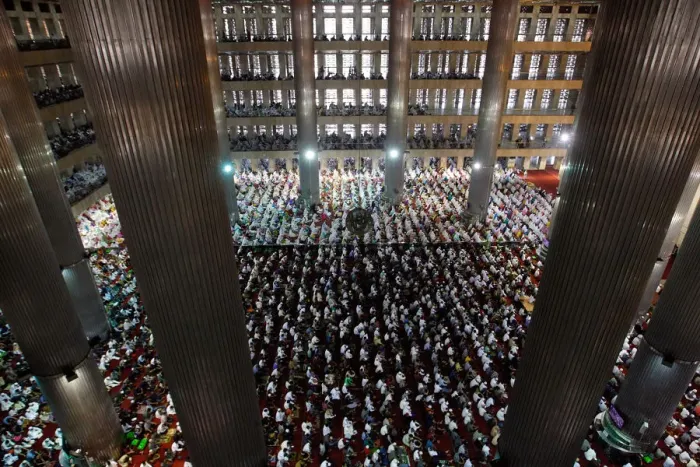 Framed Print : People attend prayers for the Muslim holiday of Eid Al-Adha at Istiqlal Mosque in Jakarta