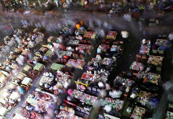 People eat their Iftar meal as they break their fast during the holy fasting month of