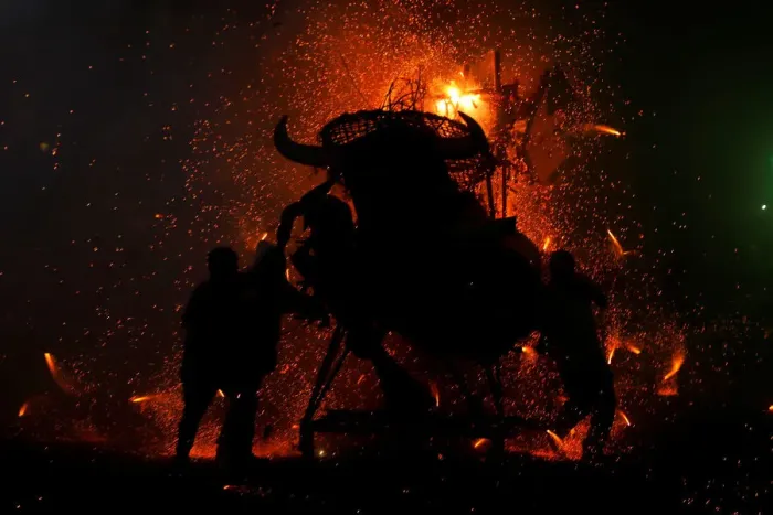 Framed Print : People enjoy fireworks exploding from a traditional bull figure known as El Torito in Framed Print : People enjoy fireworks exploding from a traditional bull figure known as El Torito in