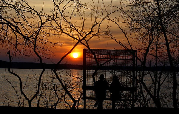 People enjoy sunset at a lake on the outskirts of Minsk