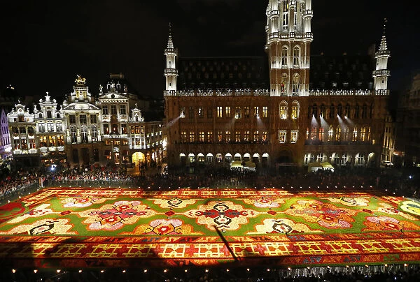 People gather around a giant flower carpet at Brussels Grand Place